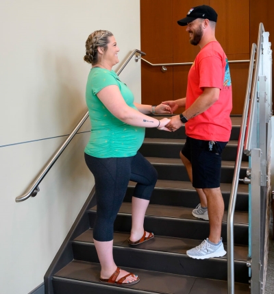 pregnant woman holding hands of husband